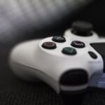 Close-up of a white gaming controller on a dark background